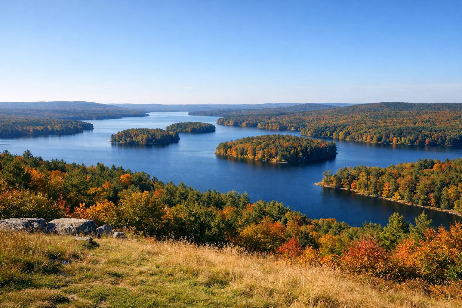 Large reservoir with wooded islands seen from a hilltop